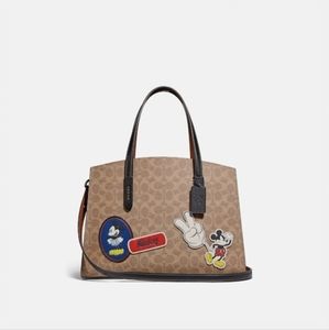 Disney X Coach Charlie Carryall In Signature Canvas With Patches